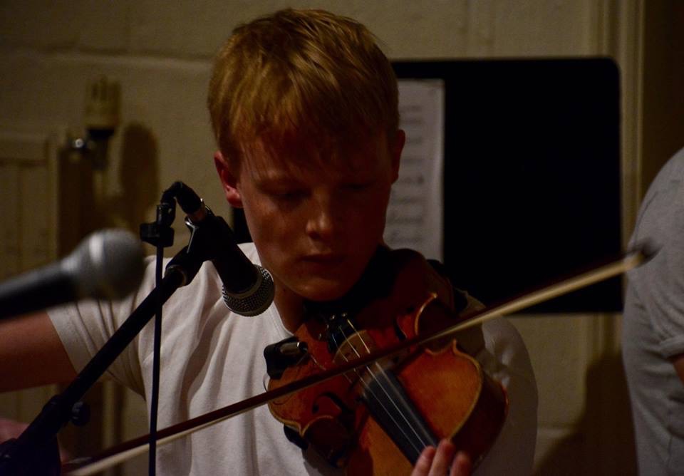 Morgan Marshall playing violin in an intimate live performance